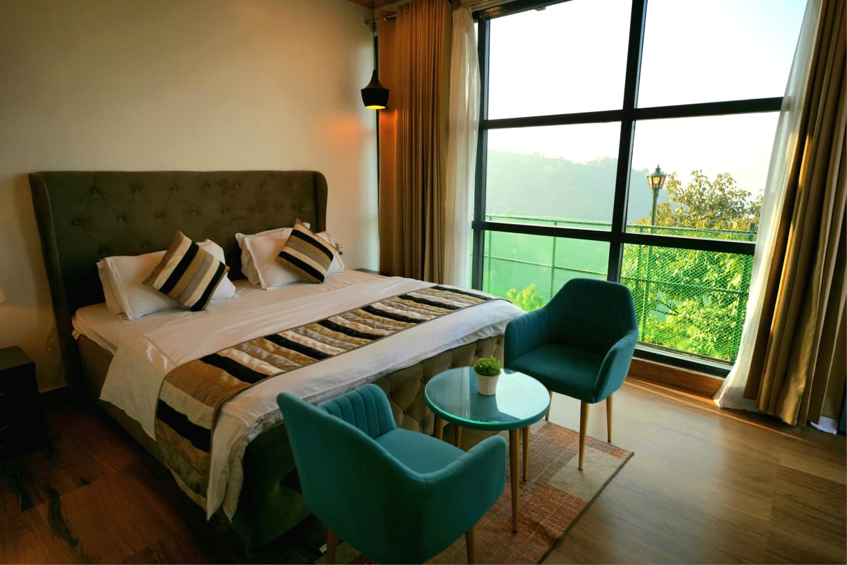 Luxury villa room with floor-to-ceiling valley view window